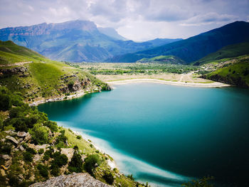 High angle view of lake amidst mountains against sky