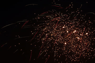 Low angle view of firework display at night