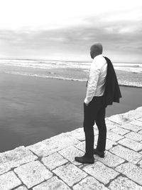 Rear view of man looking at sea shore