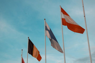 Low angle view of flag flags against sky