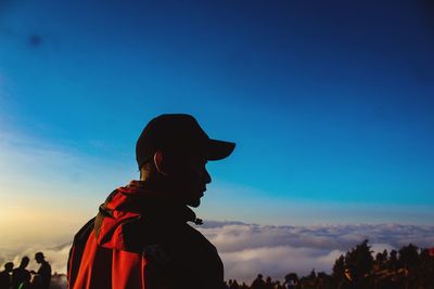 Low angle view of silhouette man standing against sky during sunset