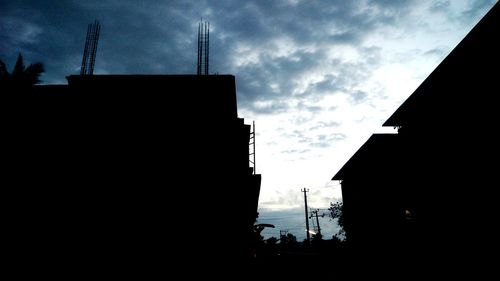 Low angle view of silhouette buildings against sky at dusk