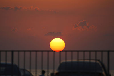 Sun shining over sea during sunset