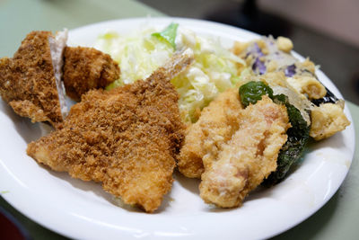 Close-up of fried meat and salad in plate