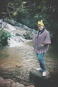 Full length of girl standing by stream