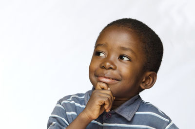 Portrait of cute boy against white background