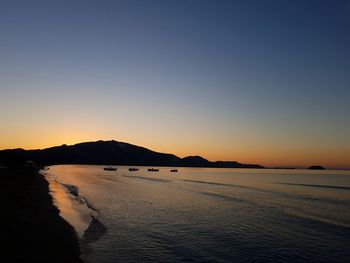 Scenic view of sea against clear sky during sunset