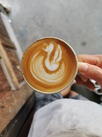 Hand holding coffee cup