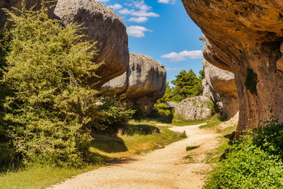 Road amidst rocks against sky