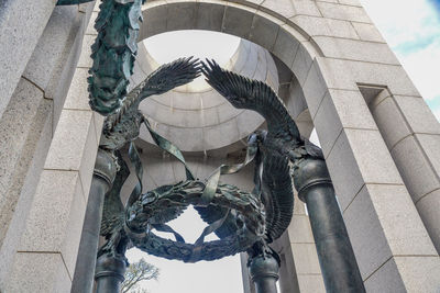 Low angle view of statue against historic building