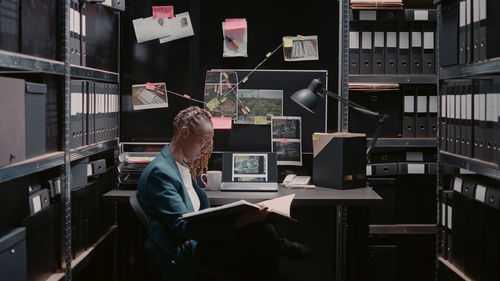 Rear view of man using digital tablet in office