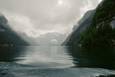 Scenic view of lake by mountains against sky