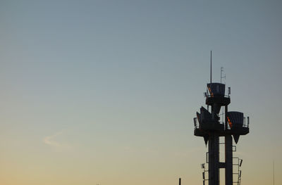 Low angle view of communications tower against sky