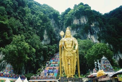 Statue of buddha against trees