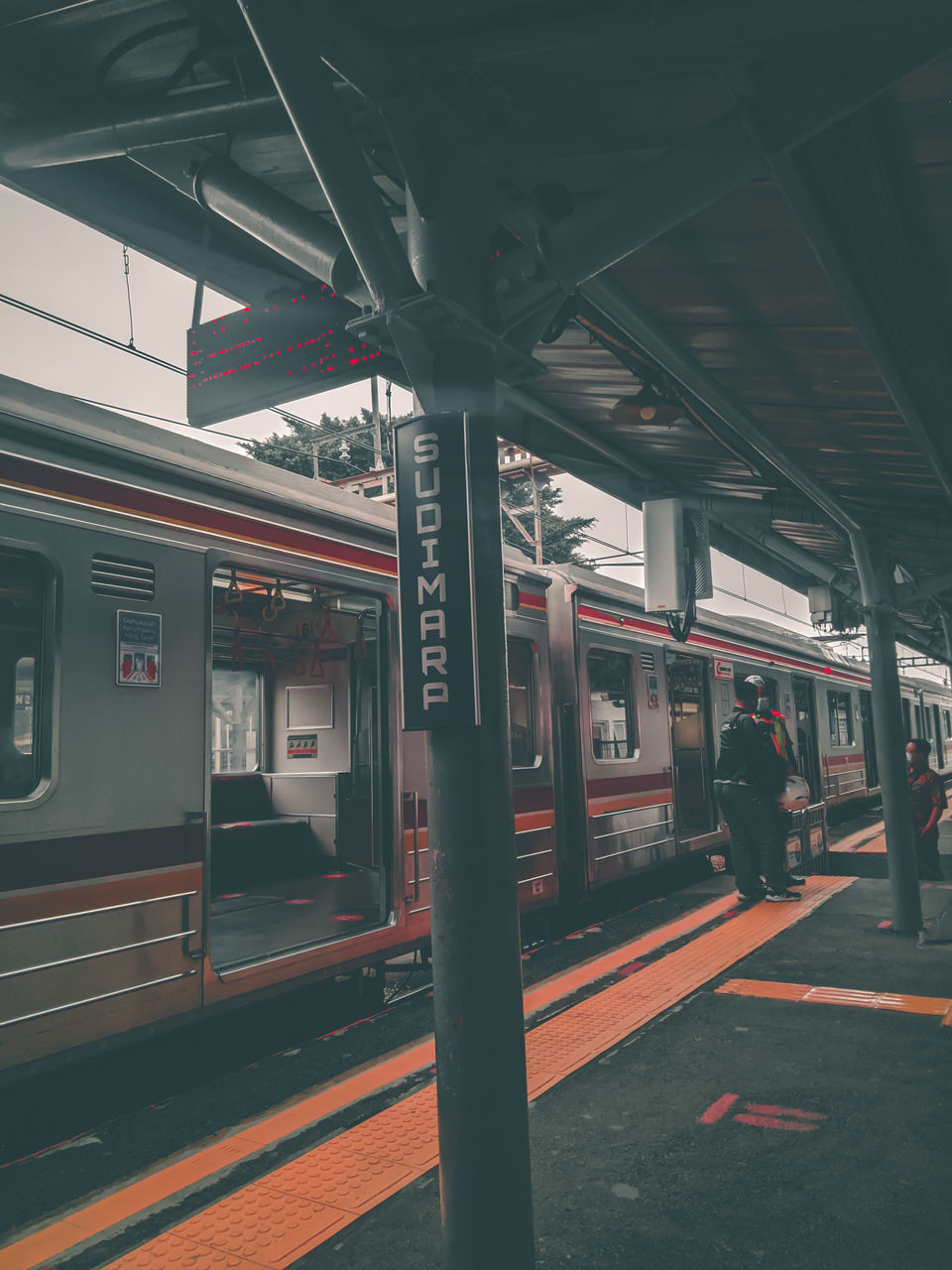 TRAIN IN RAILROAD STATION PLATFORM