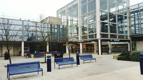 Empty seats in city against sky