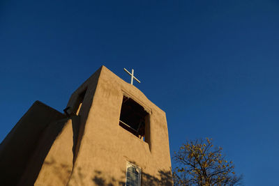 Low angle view of building against clear blue sky