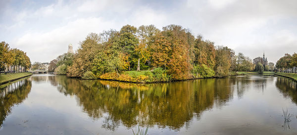 Scenic view of lake by trees against sky