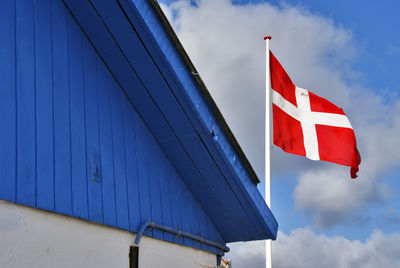 Low angle view of denmark flag against sky