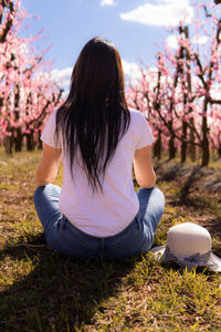 Young woman sitting on field