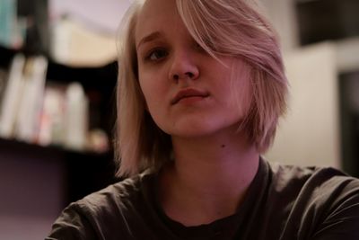 Close-up portrait of young woman at home