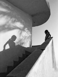 Low angle view of girl standing on staircase