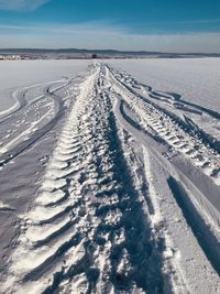 Tire tracks on snow covered land