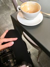 Cropped image of hand holding coffee cup