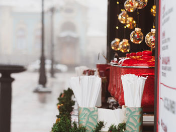 Christmas fair street food stall red pot mulled wine hot drink holiday market illuminated decoration