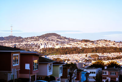 Houses in town against sky during winter