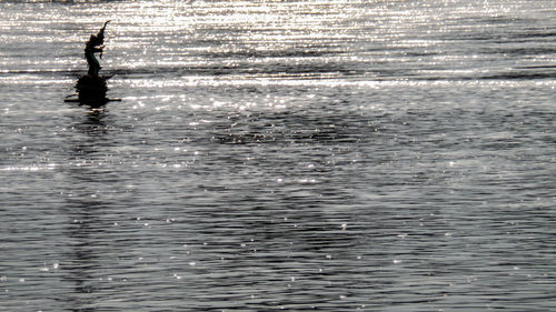 Silhouette man in sea