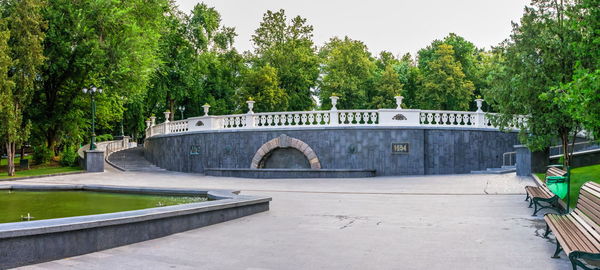 Arch bridge over river against sky