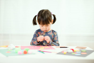 Portrait of boy playing with table