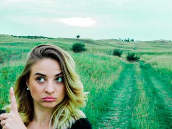 Portrait of young woman in field