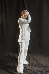 Young stylish woman businesswoman in white suit