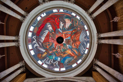 Directly below shot of ornate ceiling in building