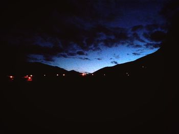 Silhouette landscape against sky at night