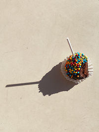 High angle view of candies on sand