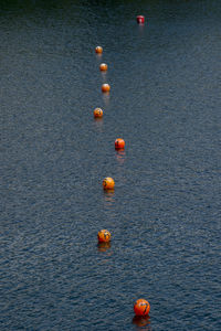 High angle view of buoys in lake