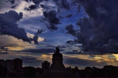 Low angle view of building against cloudy sky