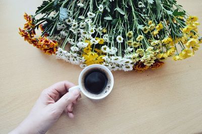 Midsection of person holding cup of coffee 