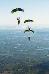 People paragliding against sky