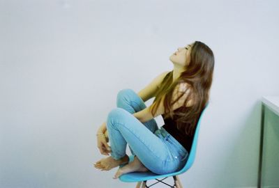 Portrait of young woman over white background