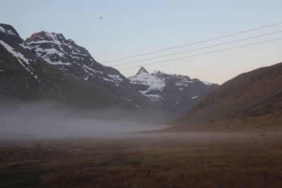 Scenic view of mountains against sky during foggy weather