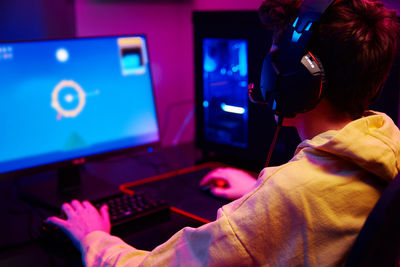 Boy plays computer game at home, gaming addiction