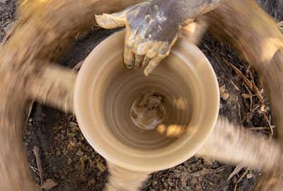 Cropped hand of man working on pottery wheel