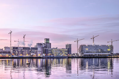 Rotterdam grain silo and construction cranes at sunrise