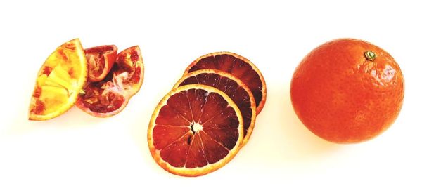 Close-up of orange fruits against white background