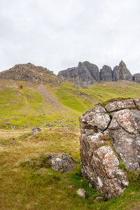 Track leading up to old man of storr, isle of skye. large weathered rock in foreground.