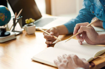 Close-up of business colleagues working in office